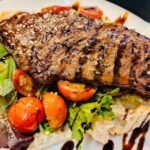 Cajun spices sirloin steak, sandwich, caramelised onion, slow cooked tomatoes, with balsamic reduction