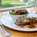 Open beef steak sandwich with wild mushrooms, Organic salad, pepper sauce